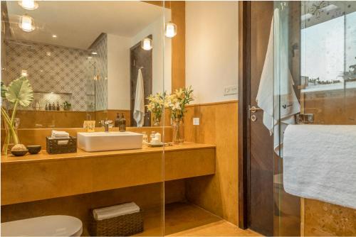 a bathroom with a sink and a mirror at La Zamora, 3BHK Villas near Vagator & Anjuna Beach, North Goa with Private Pool, Garden, Terrace & Security in Assagao
