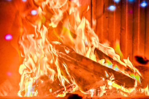 a fire is burning in a fire oven at Elexus Predeal in Predeal