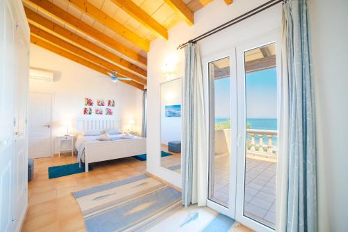 a bedroom with a view of the ocean at S'EMBAT in Colonia de Sant Pere
