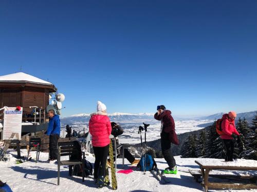 a group of people standing on top of a snow covered mountain at Vila Renáta - Apartmán Renáta 12 in Ružomberok