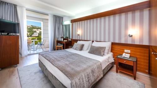 Postel nebo postele na pokoji v ubytování Hotel Uvala