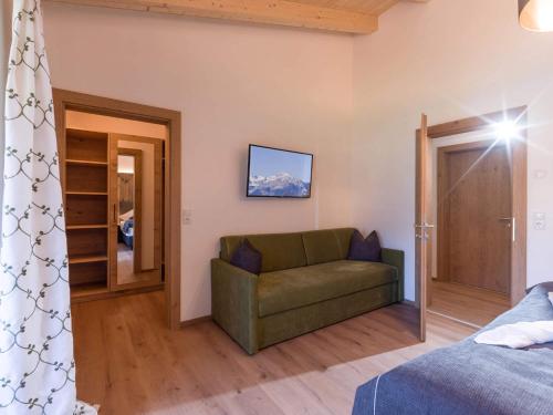 a living room with a couch and a door at Baderer Apart in Stumm