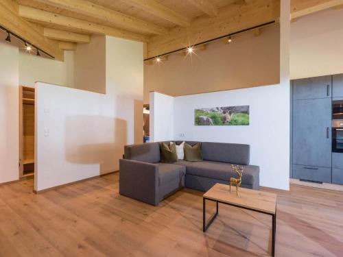 a living room with a couch and a table at Baderer Apart in Stumm