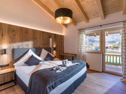 a bedroom with a bed and a large window at Baderer Apart in Stumm