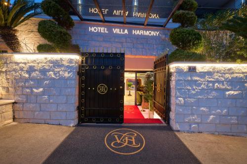a hotel lobby with a black door and a red carpet at Hotel Villa Harmony in Split