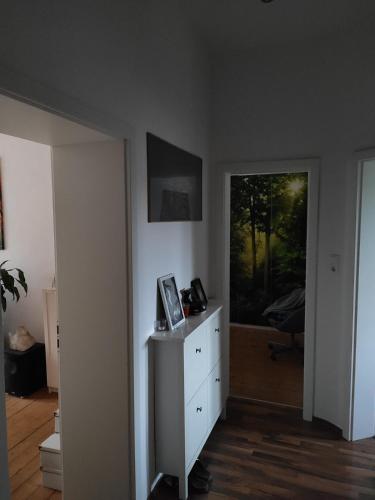 a room with a white dresser and a window at Joanna Apartment - MA Rheinau 4 in Mannheim