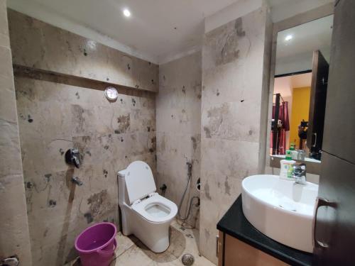 a bathroom with a toilet and a sink at Joey's Hostel Agra in Agra