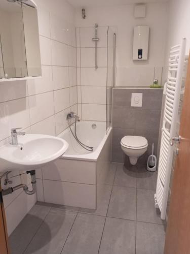 a bathroom with a sink and a tub and a toilet at Monteurzimmer/Ferienwohnung Bottrop in Bottrop