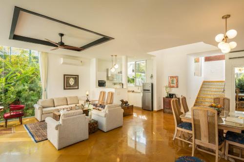 a living room with a couch and a table at La Zamora, 3BHK Villas near Vagator & Anjuna Beach, North Goa with Private Pool, Garden, Terrace & Security in Assagao