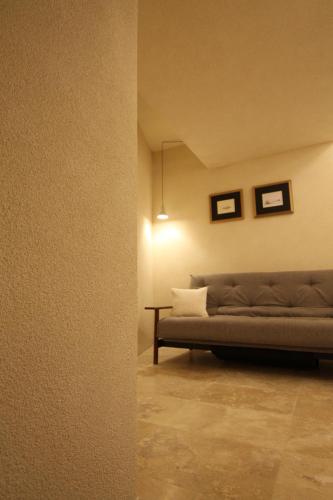 a living room with a couch and a table at The King George Village Boutique Living in Għargħur
