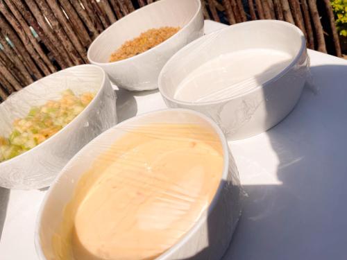 four plastic containers with food in them on a table at Motjatji B&B in Burgersfort