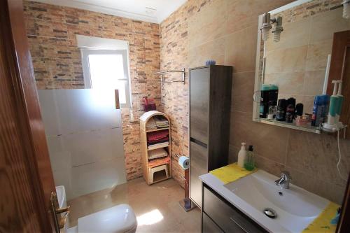 a bathroom with a sink and a shower and a toilet at Villa LILAS in Els Poblets in Els Poblets