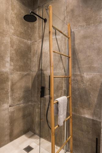 a shower with a wooden ladder in a bathroom at Rivière Residence Paros in Naousa