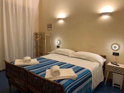 a bedroom with a large bed with towels on it at Poggio del sole in Laigueglia