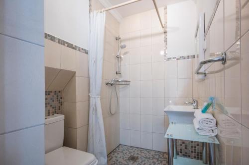 a bathroom with a toilet and a sink and a shower at Casa Margot 6 in Jávea