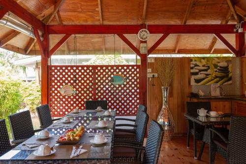 a dining room with a long table and chairs at Casa De Leela Self Catering Guest House in La Digue