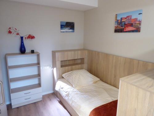 a small bedroom with a bed and a dresser at Studio Apartment 2 in Tübingen