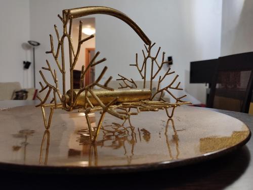 a metal sculpture of a plant on a table at CASA MIKY in Palermo