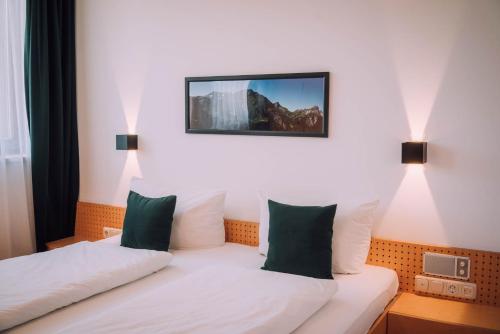 a hotel room with two beds and a tv on the wall at Apartment Mohnenfluh in Schröcken
