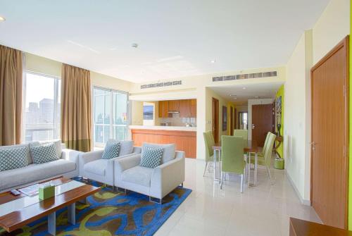 a living room with two couches and a table at Ramada by Wyndham Downtown Dubai in Dubai