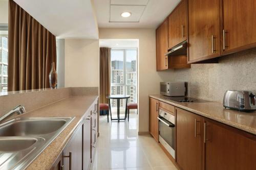 a kitchen with a sink and a counter top at Ramada by Wyndham Downtown Dubai in Dubai
