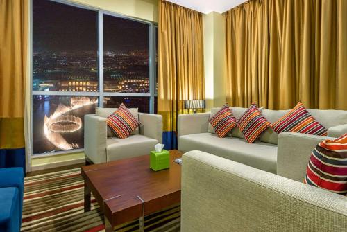 a living room filled with furniture and a window at Ramada Downtown Dubai in Dubai