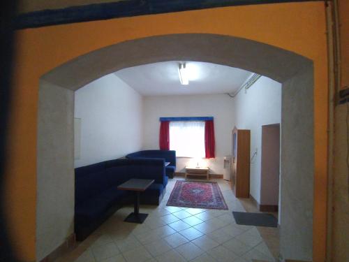 a living room with a blue couch and a window at LINDENHOF WALDHEIM in Waldheim