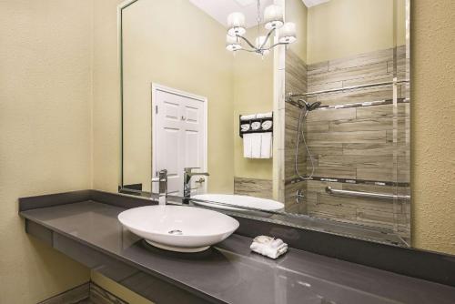 a bathroom with a sink and a mirror at La Quinta by Wyndham Laredo Airport in Laredo