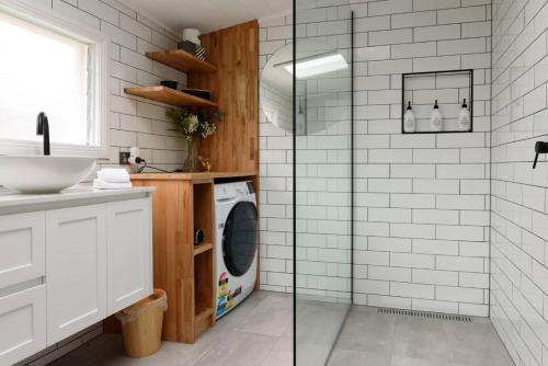 a bathroom with a sink and a washing machine at Prospect Cottage Ballarat in Ballarat