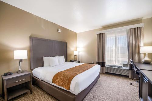 a hotel room with a large bed and a window at Comfort Inn in Bossier City