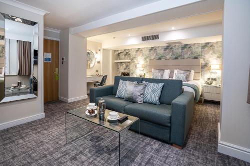 a living room with a couch and a bed at Castle Green Hotel In Kendal, BW Premier Collection in Kendal