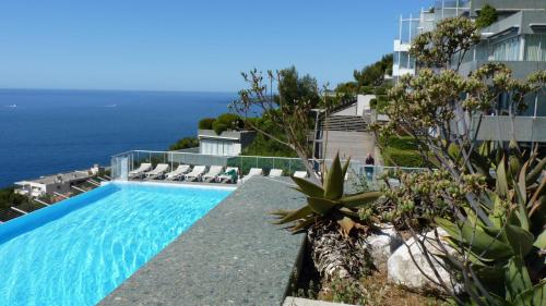 a swimming pool with a view of the ocean at Sunny Home- Residence Costa Plana in Cap d'Ail