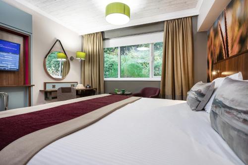 a hotel room with a large bed and a window at Castle Green Hotel In Kendal, BW Premier Collection in Kendal