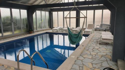 a swimming pool with a hammock in a house at Holiday Home Bogumila in Risan