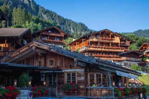a group of wooden buildings in a mountain at Ferienwohnung Alpbachtal in Radfeld