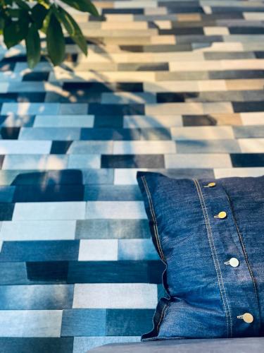 a blue pillow sitting on a checkered floor at hotel the textile in Gifu