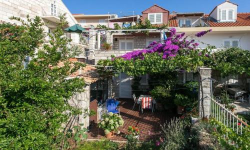 a house with a garden with purple flowers at Guest House Misita in Dubrovnik