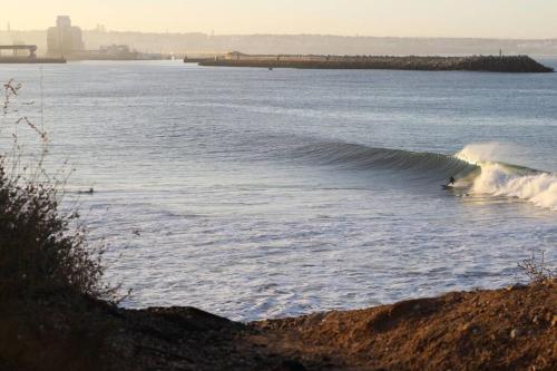 a person riding a wave on a surfboard in the water at Ait Mouli Surf House in Safi