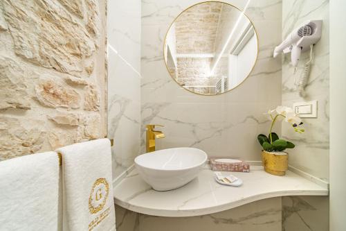 a bathroom with a sink and a mirror at Gold Suite B&B in Santeramo in Colle