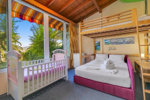 a childs bedroom with a crib and a bunk bed at Villa Laguna in Vourvourou