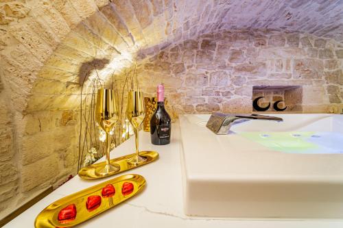 a counter with a sink and a bottle of wine at Gold Suite B&B in Santeramo in Colle