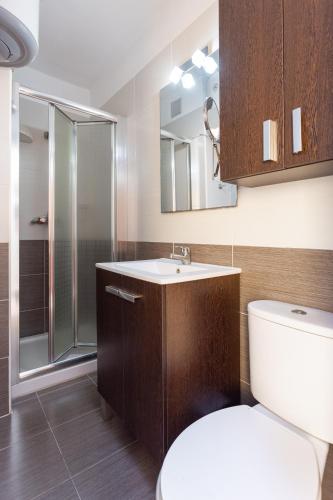 a bathroom with a toilet and a sink and a shower at Home2Book Cozy Beachfront Retreat in El Médano in El Médano