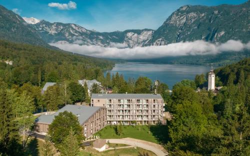 a hotel with a view of a lake and mountains at Hotel Bohinj in Bohinj