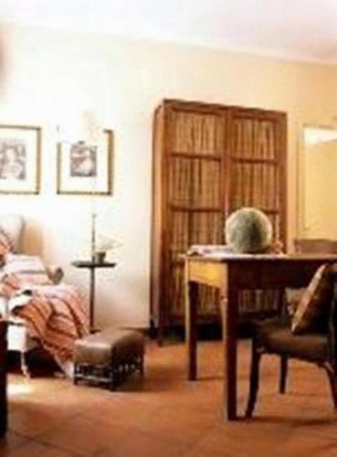 a living room with a table and a book shelf at Albergo Residence Perosi in Tortona