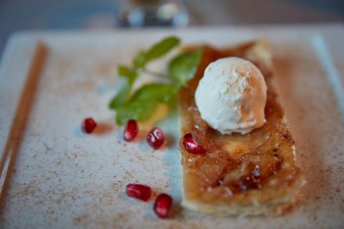 a piece of food with a scoop of ice cream on top at Victoria - Alpine Boutique Hotel & Fine Dining in Meiringen