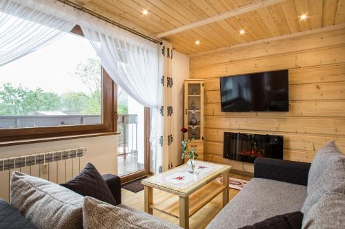 Televízia a/alebo spoločenská miestnosť v ubytovaní ApartHost Tatra Panorama