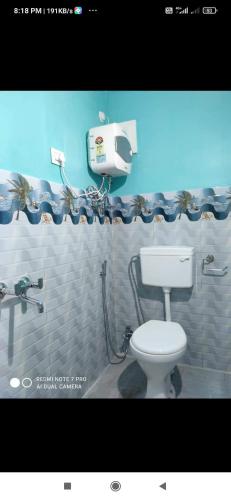 a bathroom with a toilet and a shower curtain at Swarna Kamal Homestay in Darjeeling