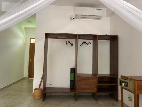a cabinet in a room with two bats on the wall at Garden Villa Talalla in Talalla
