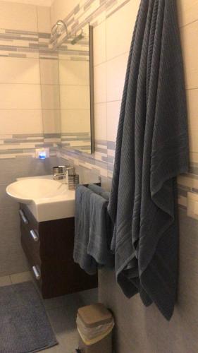 a bathroom with a sink and a blue towel at Relax Home in Bari