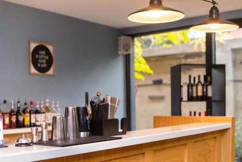 a bar with a counter with bottles of wine at Urban Park Hotels in Tbilisi City